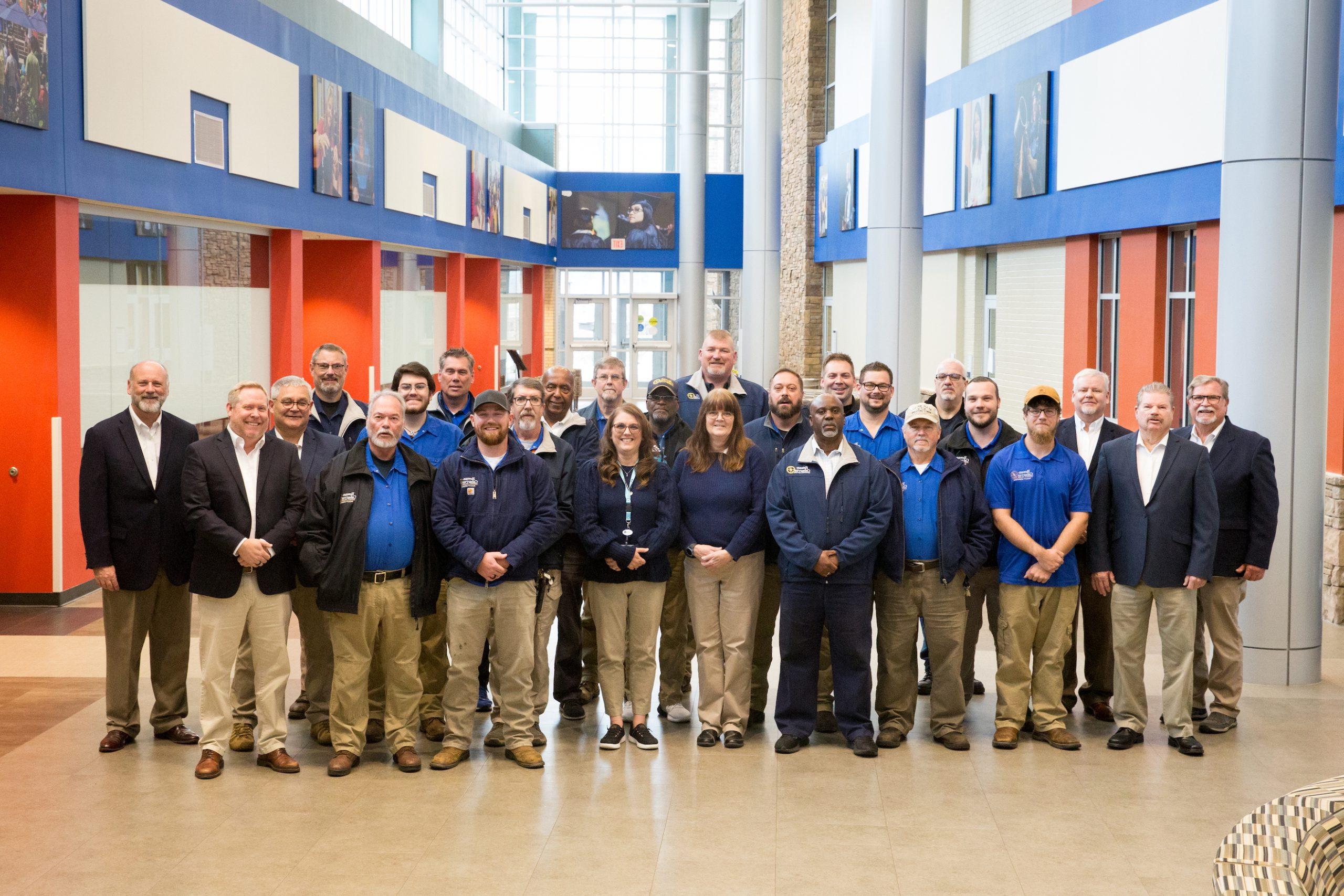 College Environment staff pose for group photo in Atrium on North Campus